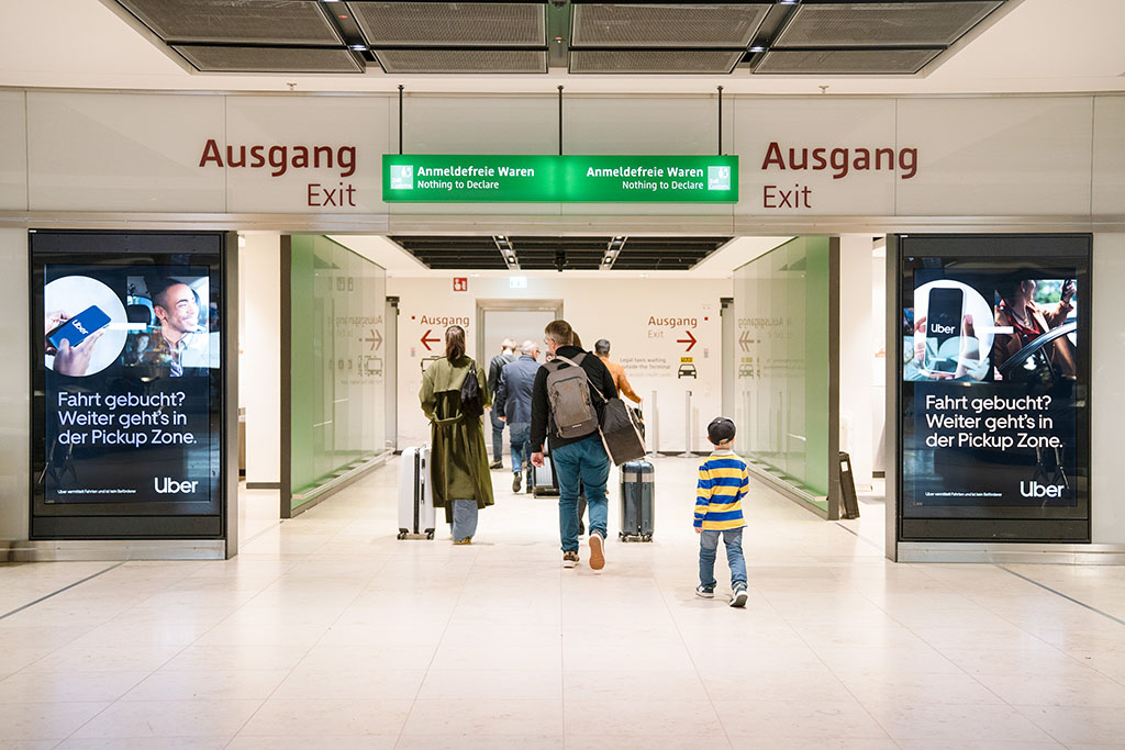 Poster display case baggage claim area