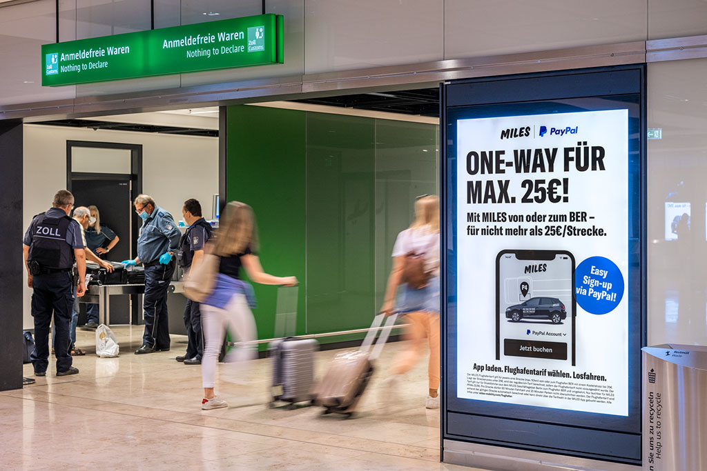 Poster display case baggage claim area